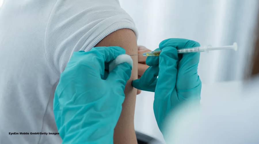 A healthcare professional administering a flu vaccine to a patient as part of H1N1 preventive measures in Sindh hospitals.