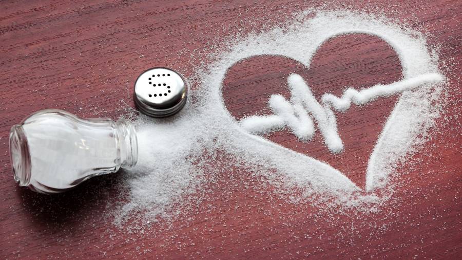 Potassium-enriched salt substitute next to regular salt, highlighting heart health benefits.